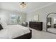 Bright bedroom featuring a cozy chair, dresser, and a view of the outdoors at 1625 Banks View Dr, Raleigh, NC 27603