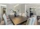 A contemporary dining room features striped chairs, a modern light fixture, and hardwood floors at 1625 Banks View Dr, Raleigh, NC 27603