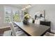 An inviting dining room boasts natural light, views of greenery, seating for six, and contemporary decor at 1625 Banks View Dr, Raleigh, NC 27603