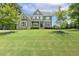 Beautiful two-story home with stone and gray siding and a lush green lawn at 1625 Banks View Dr, Raleigh, NC 27603