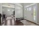Bright foyer features a decorative bench, white front door with windows, and hardwood floors at 1625 Banks View Dr, Raleigh, NC 27603