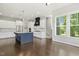 Well-lit kitchen with a large island, stainless steel appliances, and dark hardwood floors at 1625 Banks View Dr, Raleigh, NC 27603