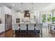 Modern kitchen with a navy blue island, pendant lights, stainless steel appliances, and hardwood floors at 1625 Banks View Dr, Raleigh, NC 27603