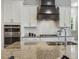Granite countertop with stainless steel sink and faucet plus a view of the backsplash, stove top, and oven at 1625 Banks View Dr, Raleigh, NC 27603