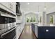 Bright kitchen with stainless steel appliances, center island, and views to the backyard at 1625 Banks View Dr, Raleigh, NC 27603