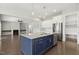 Open concept kitchen with large island, stainless steel appliances, and open view to living room at 1625 Banks View Dr, Raleigh, NC 27603