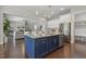 Kitchen island with granite countertops and stainless steel appliances overlooking open floor plan at 1625 Banks View Dr, Raleigh, NC 27603