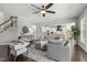 Bright living room featuring a large gray sectional sofa, ceiling fan, and open access to the kitchen at 1625 Banks View Dr, Raleigh, NC 27603