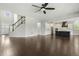 Open-concept living area with hardwood floors, staircase, and kitchen views at 1625 Banks View Dr, Raleigh, NC 27603