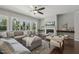 This living room has a fireplace, TV, large windows, plush sofa, and neutral tones at 1625 Banks View Dr, Raleigh, NC 27603