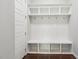 Mudroom with built-in storage featuring shelving, hooks, and a bench seat at 1625 Banks View Dr, Raleigh, NC 27603