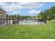 Fenced community pool surrounded by green grass, trees, and blue skies providing the perfect spot to relax at 1625 Banks View Dr, Raleigh, NC 27603