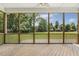 Screened-in porch featuring wood floors and views of the lush backyard at 1625 Banks View Dr, Raleigh, NC 27603