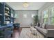 Comfortable sitting room features a built-in desk, modern lighting, and three windows at 1625 Banks View Dr, Raleigh, NC 27603