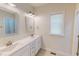 Bright bathroom featuring double sinks, marble countertops, and a large window at 167 Sequoia Dr, Timberlake, NC 27583