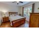 Charming bedroom featuring a wooden bed frame, ceiling fan, and natural light from the window at 167 Sequoia Dr, Timberlake, NC 27583
