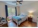Bright bedroom with a ceiling fan, wood floors, and a comfortable bed next to a workstation at 167 Sequoia Dr, Timberlake, NC 27583