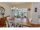 Bright dining area featuring a large window, chandelier, and rustic wood table at 167 Sequoia Dr, Timberlake, NC 27583