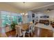 Bright dining area with large windows, hardwood floors, and elegant chandelier, creating an ideal space at 167 Sequoia Dr, Timberlake, NC 27583