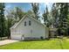 Side view of a well-maintained home with an attached garage, screened porch, and well-kept lawn at 167 Sequoia Dr, Timberlake, NC 27583