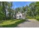 Charming home with a well-manicured lawn, a garage, mature trees, and a paved driveway at 167 Sequoia Dr, Timberlake, NC 27583