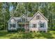 Charming home featuring tidy landscaping, a welcoming front porch, and a classic American flag at 167 Sequoia Dr, Timberlake, NC 27583