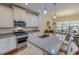 The kitchen features modern appliances, granite countertops, and a breakfast bar that overlooks the dining area at 167 Sequoia Dr, Timberlake, NC 27583