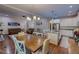Open-concept kitchen and dining area with stainless steel appliances, granite countertops, and stylish lighting at 167 Sequoia Dr, Timberlake, NC 27583