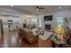 Bright open-concept living room with a fireplace, hardwood floors, and seamless flow to the kitchen and dining area at 167 Sequoia Dr, Timberlake, NC 27583