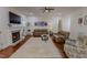 Inviting living room with a cozy fireplace, hardwood floors, and ample seating at 167 Sequoia Dr, Timberlake, NC 27583