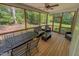 Relaxing screened-in porch with comfortable seating and views of the wooded backyard, ideal for outdoor living at 167 Sequoia Dr, Timberlake, NC 27583