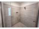 Modern shower with tiled walls, glass door, and rainfall shower head at 167 Sequoia Dr, Timberlake, NC 27583