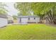 Large backyard features a well-kept lawn, a privacy fence, and a storage shed at 1708 Forest Rd, Durham, NC 27705