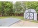 Spacious backyard with well-maintained lawn, storage shed and a concrete patio at 1708 Forest Rd, Durham, NC 27705