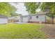Expansive backyard boasts mature trees, a well-maintained lawn and a privacy fence at 1708 Forest Rd, Durham, NC 27705
