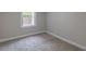 Bedroom with neutral carpet, paint and trim and bright window at 1708 Forest Rd, Durham, NC 27705