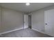 Bedroom with carpeted floor, neutral-toned walls, and a closet and entry door at 1708 Forest Rd, Durham, NC 27705