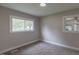 Bedroom featuring a window with views to the backyard and neutral toned walls at 1708 Forest Rd, Durham, NC 27705