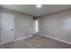 Bedroom features neutral-toned walls, carpet, closet, and entry door at 1708 Forest Rd, Durham, NC 27705
