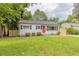 Charming single-story home featuring a well-maintained lawn and an inviting orange front door at 1708 Forest Rd, Durham, NC 27705