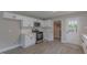 Beautiful kitchen featuring white cabinets, stainless steel appliances, and a tiled backsplash at 1708 Forest Rd, Durham, NC 27705