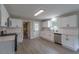 Bright kitchen featuring white cabinets, stainless steel appliances, and tiled backsplash at 1708 Forest Rd, Durham, NC 27705