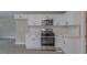 Bright kitchen featuring white cabinets, stainless steel appliances and modern subway tile backsplash at 1708 Forest Rd, Durham, NC 27705