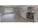 Open-concept living room and kitchen featuring modern appliances and sleek countertops at 1708 Forest Rd, Durham, NC 27705