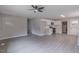 Open-concept living room leading to a modern white kitchen with stainless steel appliances at 1708 Forest Rd, Durham, NC 27705