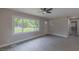Bright living room featuring vinyl floors, neutral walls, and large windows providing ample natural light at 1708 Forest Rd, Durham, NC 27705