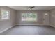 Spacious living room with windows providing natural light and a ceiling fan at 1708 Forest Rd, Durham, NC 27705