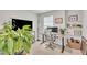 Bright home office space with an adjustable desk, a large screen TV, and natural light at 1729 Starlit Sky Ln, Cary, NC 27519