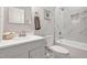 Elegant bathroom featuring white marble tile, soaking tub with shower, and modern vanity with stylish fixtures at 1824 Irish Blvd, Sanford, NC 27332