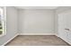 Empty bedroom with durable wood-look floors, abundant natural light, and convenient closet space at 1824 Irish Blvd, Sanford, NC 27332